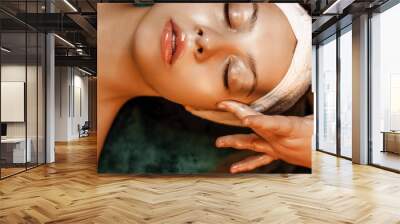 Close up of a beautiful woman doing facial procedures with hyaluronic acid in a spa salon. Wall mural