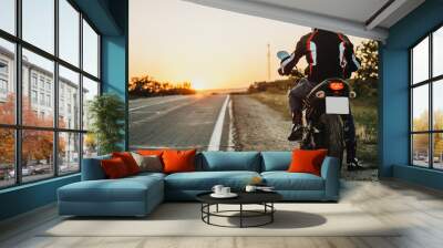 Man on motorbike riding on roadside Wall mural