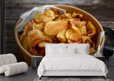 Delicious home made potato chips with sea salt and black pepper against a rustic background. Delicious snack served with sauce. Fast food.Beer snacks Wall mural