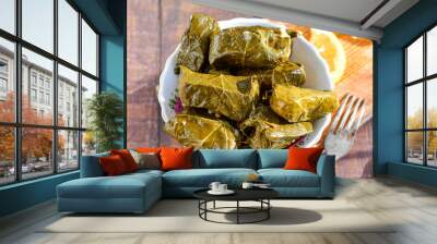 Dolmades - stuffed grape leaves  rolls  with rice the Greek way on wooden table .Stuffed greek wine leaves Wall mural