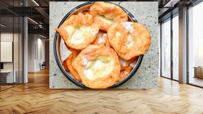 Traditional Bulgarian home made deep fried  patties  covered with sugar  оn rustic backgroud.Mekitsa or Mekica,  on wooden  rustic  background. Made of kneaded dough that is deep fried  Wall mural