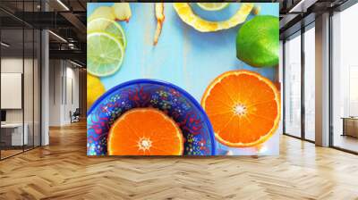 Various citrus fruits and ginger on blue cutting board Wall mural