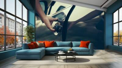 Male open the door caHand on handle. Close-up of man hand opening a car door. vintage picture style process. Wall mural