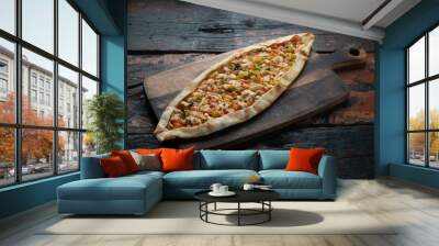 Turkish pide with chicken and vegetables isolated on rustic wooden table Wall mural