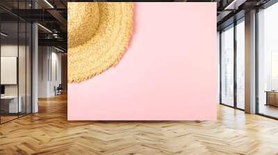 Top view of straw hat on pink background. Summer fashion, vacation and beach wallpaper. Copy space, flat lay. Wall mural