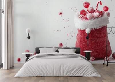 Creative composition with red Santa's sack and floating candies. Festive and cheerful with soft white background and big copy space. Wall mural