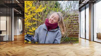 Happy woman in a garden. Wall mural