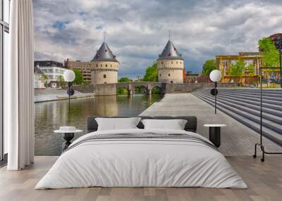 Cityscape with ancient Broel Towers, a classified monument and a landmark in the Belgian city of Kortrijk alongside the Leie river. Wall mural