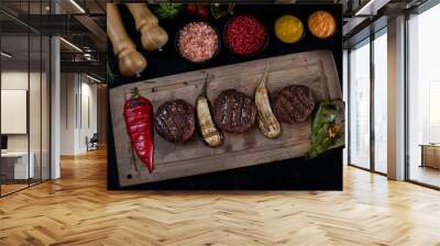 Delicious grilled meat in the plate with dark background Wall mural