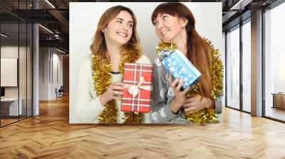 Portrait of a happy girls with gifts boxes in hands. Wall mural