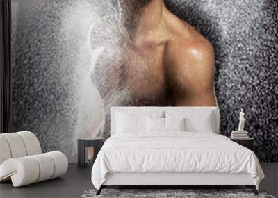 Muscular young man having shower Wall mural