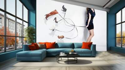 Young woman with many shoes Wall mural