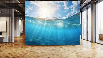 Bright sunlight shining through clear blue water. Warm summer ocean with rocky bottom. Wall mural