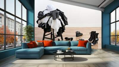 heap of clothing on a stool and disordered shoes Wall mural