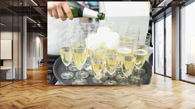 Pouring champagne in stylish glasses Wall mural