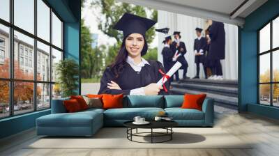 A girl graduate against the background of university graduates. Wall mural