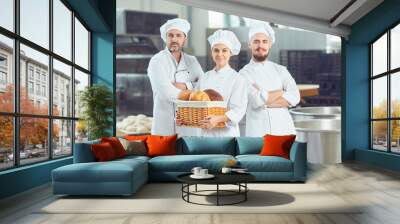 A group of bakers smiles at the bakery Wall mural