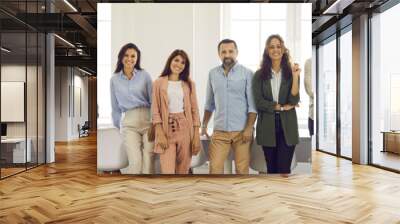 Banner with group portrait of happy successful young and mature people at work. Team of corporate employees, coworkers and business professionals standing in office, smiling and looking at camera Wall mural