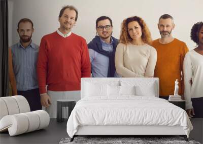 Banner with team of confident diverse people standing together. Group portrait of happy mixed race male and female models of different ages in comfortable smart casual wear posing in studio Wall mural