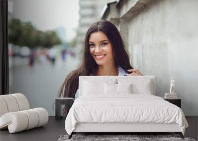 Beautiful happy brunette woman smiling outdoors.  Wall mural