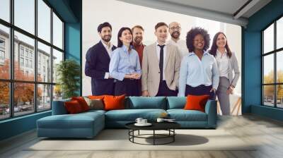 Business partners with happy and surprised facial expressions during an official meeting or event. Multiracial colleagues are watching something together and are happy about important news. Wall mural