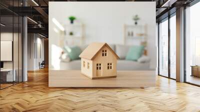 Close up of wooden house model on table in modern real estate agent office. Home building cottage maquette in realtor broker company. Bank property loan mortgage. Rent, realty concept. Wall mural