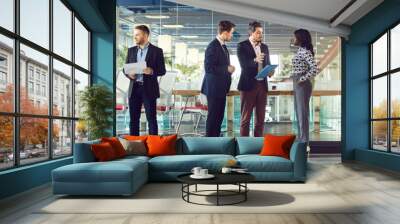 Diverse multinational business people men and women chatting after a meeting. Company employees or group of staff talking with each other in modern office during the break in meeting room. Banner. Wall mural