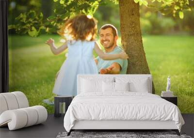 Father's day. Father plays with his daughter in the summer park. Wall mural