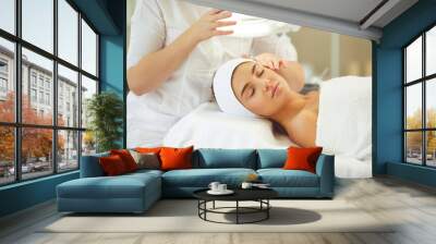 Good-looking young female getting professional skin treatment in modern beauty salon Wall mural