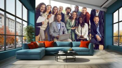 Group portrait of a happy smiling diverse business people at work in office. Staff and company employees men and women looking cheerful at the camera during a meeting or a conference. Wall mural