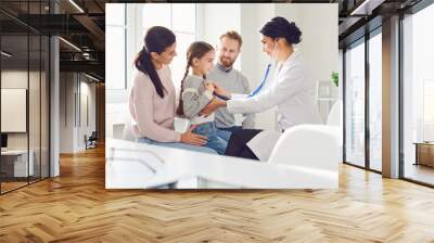 Happy family on a visit to the doctor in the office of a doctor. Wall mural