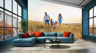 Happy family playing on nature in autumn summer. Wall mural