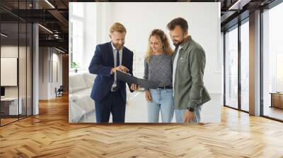 happy married couple buying new house. young husband and wife standing in white living room of parti Wall mural