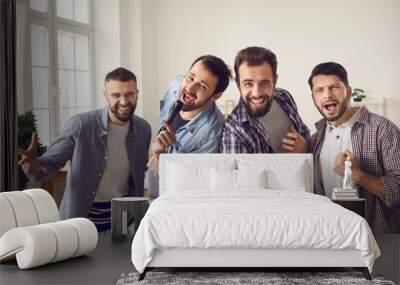 Home party and having fun for male company concept. Smiling cheerful friends men dancing singing feeling excited and enjoying time together at home during party or celebration Wall mural