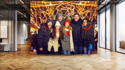 Laughing people standing on Christmas market Wall mural