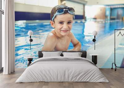 Little boy smiling child smiling at swimming pool indoors. Wall mural