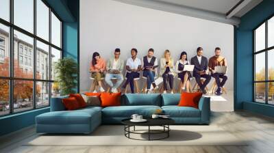 Modern way to communicate. Woman in row with people who came for interview and are busy reading resumes or surfing internet. Concept of human resources, employment, customers and electronic devices. Wall mural