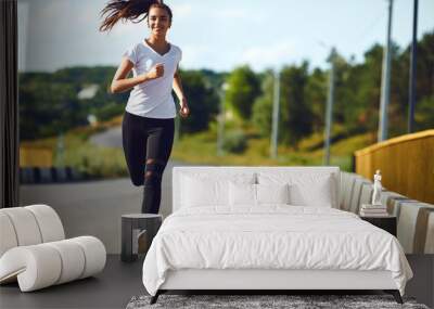 One young fitness girl runner running road Wall mural