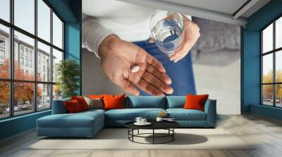 Pills tablet in hand of the girl in the room. Concept virus cold pill sick flu sickness headache flu illness Wall mural