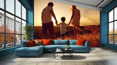 Rear view of family standing in nature at sunset Wall mural