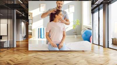 Rehabilitation, head, neck therapy by professional doctor, trainer nurse, manual therapy chiropractor helping female patient, physical therapist doctor massage to cure injury trauma, traumatologist Wall mural