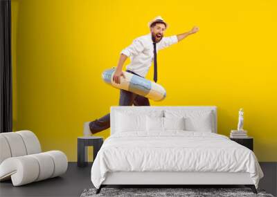 Side profile view funny happy joyful excited man office worker in white shirt, black tie, trousers, sun hat and beach ring running isolated on yellow color background. Summer holiday, vacation concept Wall mural