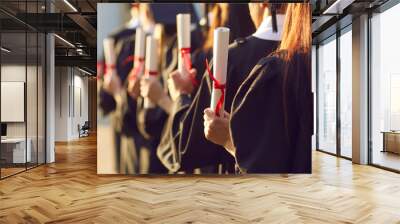 Student holding diploma degree certificate scroll at college or university graduation ceremony. High academic education accomplishment concept. Party celebration for academy graduates Wall mural