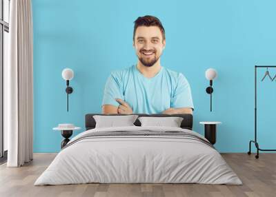 studio shot of a happy young man in casual clothes. portrait of a cheerful handsome guy in a blue t  Wall mural