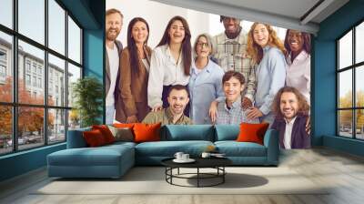 Team of happy diverse business people at work in office. Group of cheerful young and mature mixed race men and women in smart casual clothes looking at camera and smiling. Web banner header background Wall mural