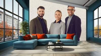 Team of positive smiling confident mixed-race co-founders of successful business startup company. Group portrait of happy young diverse coworkers, managers or business partners looking at camera Wall mural