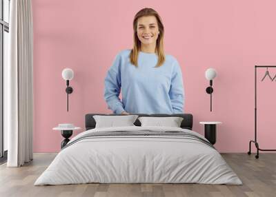 young model posing in studio. studio shot of cheerful woman in casual outfit. happy smiling teen gir Wall mural