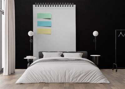 white notebook and colorful post-it on black background, isolated. taking note. blank paper. new year's resolution, goals. 2021. soft yellow, green and blue. to do list. Wall mural