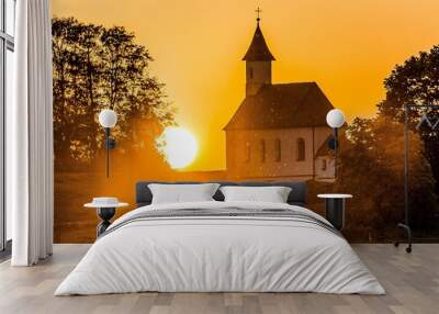 Beautiful view of St. Rupert church also known as Lindach on an orange sunset background Wall mural