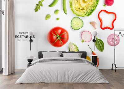 Creative layout made of summer vegetables. Food concept. Tomatoes, onion, cucumber, green peas, garlic, cabbage, chilly pepper, yellow pepper, salad leaves and radish on white background. Wall mural